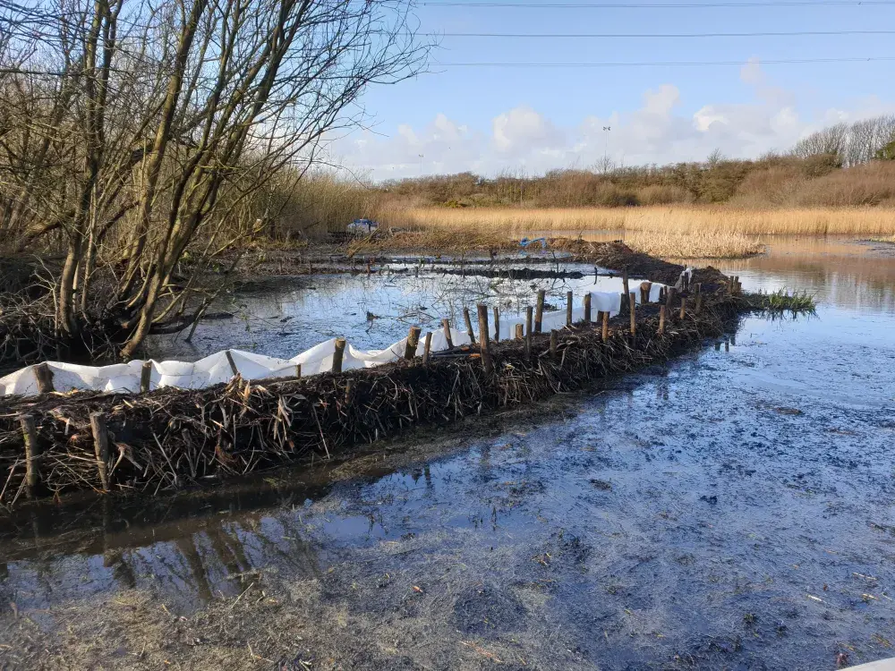 Permeable membrane bund prepared alongside a small watercourse at a northern England nature reserve