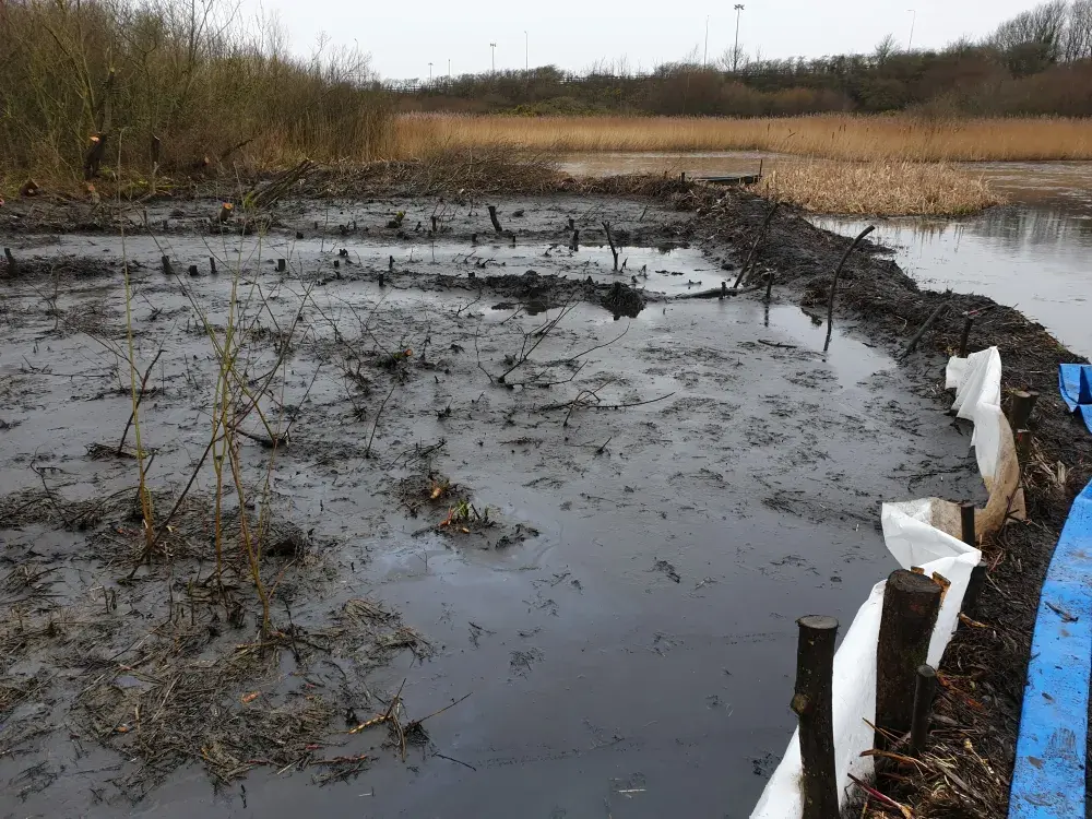 Silt pumping into a permeable membrane bund during watercourse restoration works