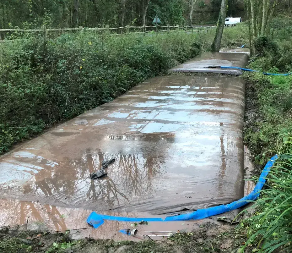Dewatering bags filled with silt during pond restoration works in Pembrokeshire