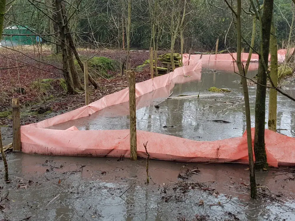 Geotextile barrier containing silt pumped from a private pond in Preston